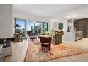 An open living room boasts an area rug, sophisticated decor, and access to the balcony at 155 Steele St # 418, Denver, CO 80206