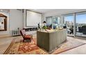 Cozy living room featuring modern fireplace and balcony access at 155 Steele St # 418, Denver, CO 80206