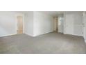 Spacious living room with plush carpet, neutral walls, and multiple doorways at 5455 Dudley Ct, Arvada, CO 80002