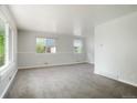 Bright living room with neutral walls, plush carpet, and ample natural light at 5455 Dudley Ct, Arvada, CO 80002