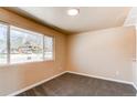 Bright bedroom with large window and neutral carpeting, offering a cozy atmosphere and natural light at 8540 Corona St, Denver, CO 80229