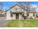 Charming home featuring a cozy front porch, lush lawn, and inviting curb appeal at 1055 Quartz St, Golden, CO 80401