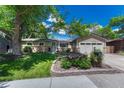 Attractive one-story home featuring a well-manicured lawn, brick accents, and a two-car garage at 4539 E Caley Pl, Centennial, CO 80121