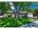 A charming one-story home surrounded by mature trees and lush greenery, offering a serene setting at 4539 E Caley Pl, Centennial, CO 80121