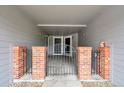 Gated entrance featuring brick pillars and access to multiple units at 1308 S Danube Way # 102, Aurora, CO 80017