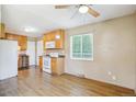Open eat-in kitchen with wooden cabinets and white appliances at 1060 Saulsbury St, Lakewood, CO 80214