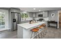 Modern kitchen island with white quartz countertop and stainless steel appliances at 3449 W Alamo Pl, Littleton, CO 80123