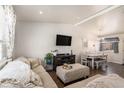 Open-concept living and dining area with modern furniture and plenty of natural light at 3953 S Richfield St, Aurora, CO 80013