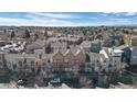 Aerial shot of colorful townhomes in a neighborhood with lots of trees and blue sky at 13640 E Iliff Pl, Aurora, CO 80014