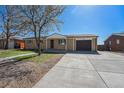 Single-story home with driveway and attached one car garage at 11674 Claude Ct, Northglenn, CO 80233