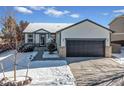 Charming single-Gathering home with a well-kept lawn, gray trim and a spacious two-car garage at 1180 Crenshaw St, Castle Rock, CO 80104