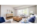 Cozy living room featuring a decorative accent cabinet, and an oversized ottoman at 1757 S Van Dyke Way, Lakewood, CO 80228
