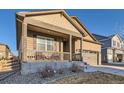 Inviting home featuring a cozy front porch perfect for relaxing and enjoying the neighborhood views at 222 Fox St, Bennett, CO 80102