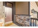 Inviting entryway with stone accents and stylish details, enhancing the curb appeal of the home at 222 Fox St, Bennett, CO 80102