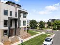 Contemporary townhome features a clean-lined facade and landscaped yard, creating curb appeal at 3103 W 18Th Ave, Denver, CO 80204
