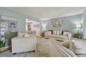 Bright living room with stylish furnishings, hardwood floors, and a view into the dining area at 1001 S Nucla St, Aurora, CO 80017