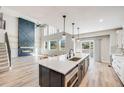Bright, spacious kitchen with a large center island, modern appliances, and an open layout to the living area at 2816 Greensborough Dr, Highlands Ranch, CO 80129