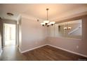 Open dining area with wood floors, decorative chandelier, and neutral paint scheme at 1785 Morrison Ct, Superior, CO 80027