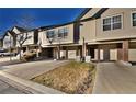 Charming townhomes with brick accents and driveways leading to attached garages at 1785 Morrison Ct, Superior, CO 80027