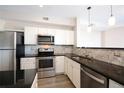 Well lit kitchen boasts stainless steel appliances, granite countertops and tiled backsplash at 1785 Morrison Ct, Superior, CO 80027