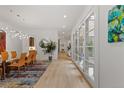 Open dining area featuring a long glass table, modern lighting, and views into other rooms at 318 Adams St, Denver, CO 80206