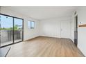 Spacious living room with access to a balcony providing natural light at 3100 S Federal Blvd # 232, Denver, CO 80236