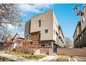 Modern home featuring clean lines, large windows, and a pergola over a brick patio at 1632 N Gilpin St, Denver, CO 80218