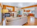 Cozy living room featuring a fireplace, hardwood floors, and an open layout to the kitchen at 1632 N Gilpin St, Denver, CO 80218
