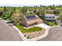 Aerial view of a home with solar panels, surrounded by mature trees and neighborhood at 3298 W 11Th Avenue Pl, Broomfield, CO 80020