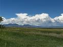Scenic view of open green space with majestic mountain views in the background, perfect for recreation and relaxation at 3298 W 11Th Avenue Pl, Broomfield, CO 80020