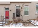 Tan colored building with red and dark brown doors, steps and small front yard at 2512 Kensing Ct, Denver, CO 80211