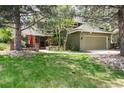 Charming two-story home with landscaped front yard, brick accents, and a cozy outdoor seating area at 4 Oakmont Ln, Littleton, CO 80127