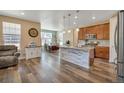 Spacious kitchen with a large center island, stainless steel appliances, and an adjacent dining area at 892 High Point Trl, Elizabeth, CO 80107