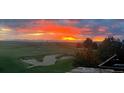 Scenic golf course view with vibrant sunset sky, providing a tranquil outdoor living experience at 1609 S Catawba Cir, Aurora, CO 80018