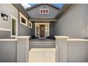 Inviting front porch with bench seating and decorated front door and sidelights at 4745 Mesa Top Dr, Monument, CO 80132