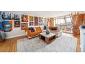 Living room with modern furnishings, art, and access to a sunny balcony at 1155 N Ash St # 806, Denver, CO 80220