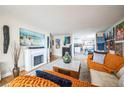 Cozy living room with fireplace, stylish decor, and open view to the kitchen at 1155 N Ash St # 806, Denver, CO 80220