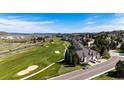 Expansive aerial image showcases a golf course community with beautiful homes and lush landscaping at 3383 Mount Royal Dr # 46, Castle Rock, CO 80104