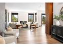 Bright living room with modern furniture, hardwood floors, and large windows with a view at 29822 Troutdale Scenic Dr, Evergreen, CO 80439
