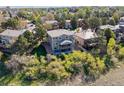 Aerial view of the home's rear exterior with a spacious yard and a deck for outdoor living at 9531 Desert Willow Way, Highlands Ranch, CO 80129