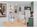 Casual dining area with adjacent kitchen, featuring built-in shelving and decor at 970 S Dawson Way # 9, Aurora, CO 80012