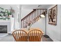 Light-filled dining area with wood table, staircase, and stylish decor at 970 S Dawson Way # 9, Aurora, CO 80012