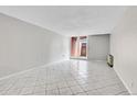 Bright living area with tile floors and a sliding glass door to the outside at 2500 S York St # 115, Denver, CO 80210