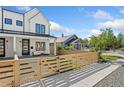 Stylish modern farmhouse with a fenced front yard and a charming outdoor seating area at 2426 Ames St, Edgewater, CO 80214