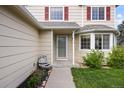 Front entrance of the home featuring a lovely fountain, fresh landscaping, and classic red window shutters at 11100 Callaway Ct, Parker, CO 80138