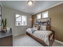 Cozy bedroom with decorative pillows, comfortable daybed, and natural light from window at 10307 Vaughn Way, Commerce City, CO 80022