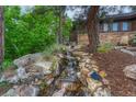 Scenic waterfall feature cascading through a rock garden, adding a touch of nature to the property at 2597 Oak Vista Ct, Castle Rock, CO 80104