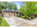 Inviting home with a long driveway and attached two-car garage, plus solar panels at 7579 Jay Ct, Arvada, CO 80003