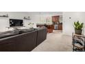 Cozy living room flowing into the kitchen with modern finishes at 7579 Jay Ct, Arvada, CO 80003