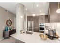 Stylish kitchen featuring stainless steel appliances, a large island, and designer lighting fixtures at 4200 W 17Th Ave # 508, Denver, CO 80204